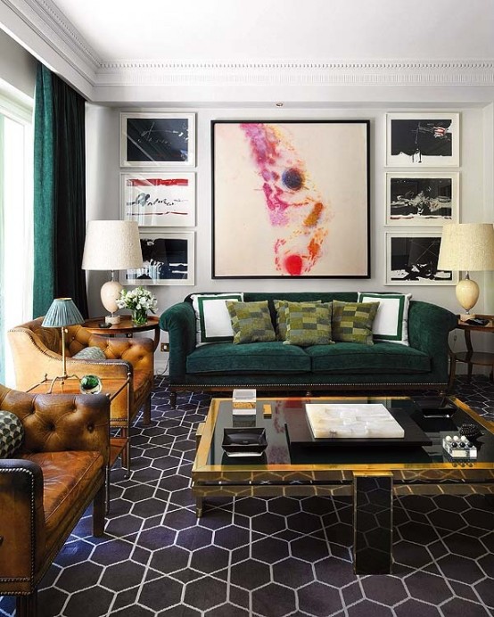 a bright modern meets art deco living room with leather and velvet furniture, artworks, a glass table and touches of gold