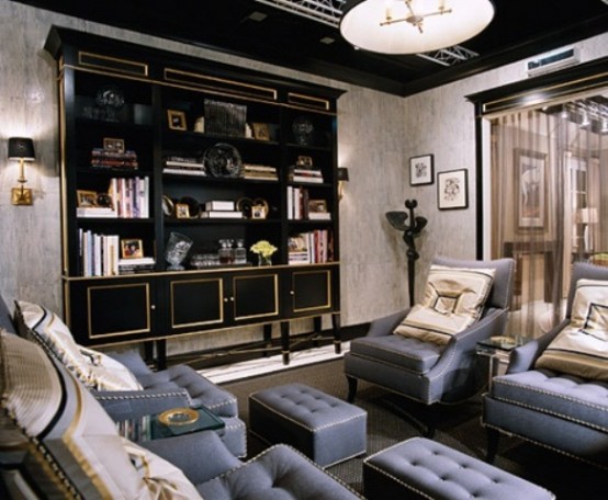 a moody and refined living room with blue furniture, a dark and gold shelvign unit, lamps and artworks