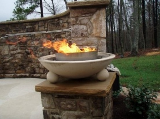 a double stone fire bowl on spheric legs is a lovely idea for an elegant and chic outdoor space with a vintage feel, place it on some stand
