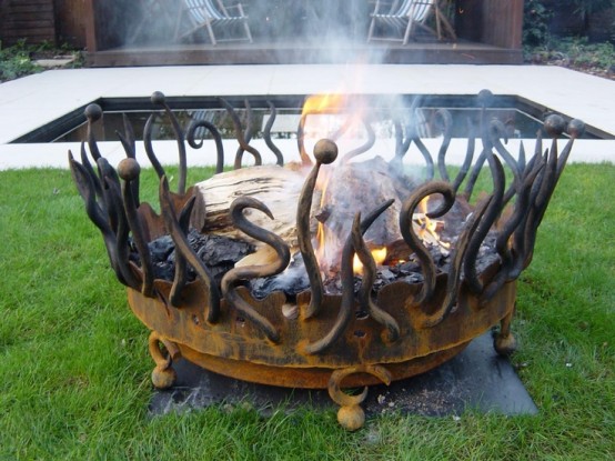 a large creative fire bowl with flames shown made of metal is a lovely idea for a relaxed backyard
