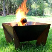 a very laconic but large metal square fire bowl with tall legs is a cool idea for a mid-century modern or rustic outdoor space