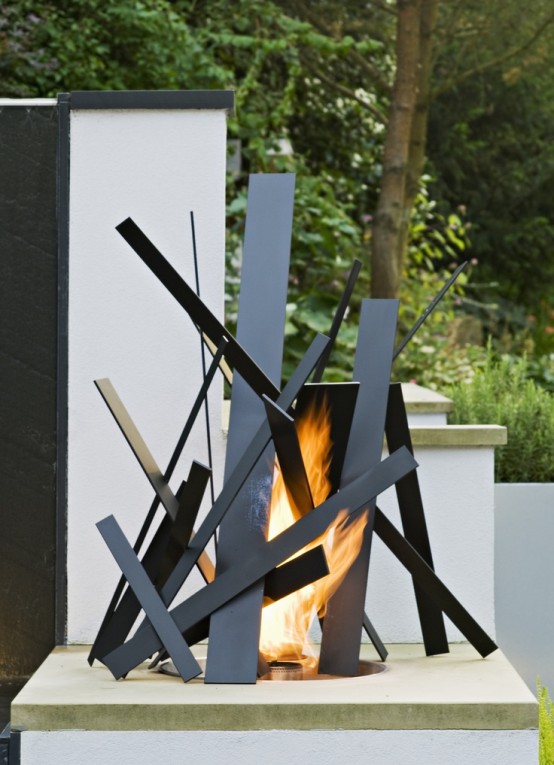 a unique modern fire bowl with metal pieces over it is not just a source of warmth and light but also an art installation, it looks gorgeous for a contemporary space