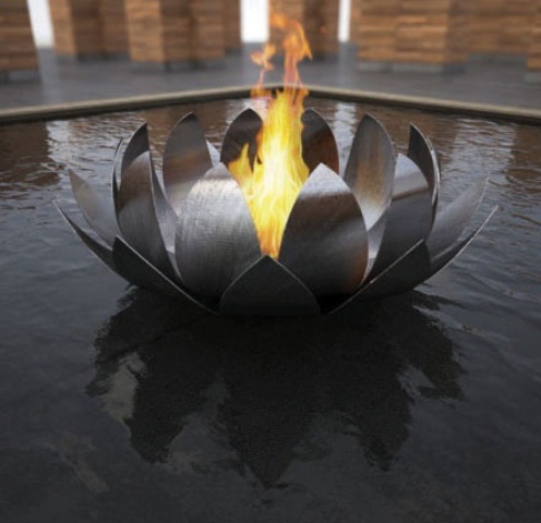 a metal water lily as a fire bowl installed right in the center of the pool is a lovely idea for pairing two elements - water and fire with a spectacular touch