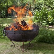 a large forged fire bowl on exquisite legs is a cool idea for any relaxed or vintage-inspired backyard