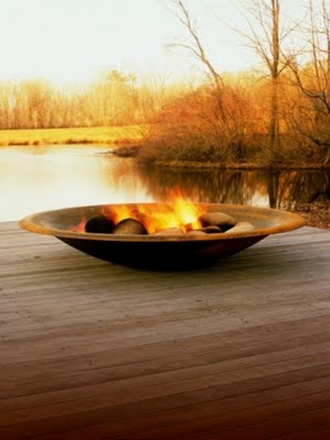 a plain metal fire bowl reminding of a usual plate is a lovely idea for a modern outdoor space or a minimalist one