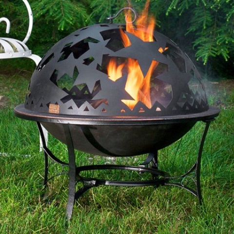 a whimsical metal outdoor fire bowl with a spheric shape, on tall legs and with star cutouts is a gorgeous idea for outdoors
