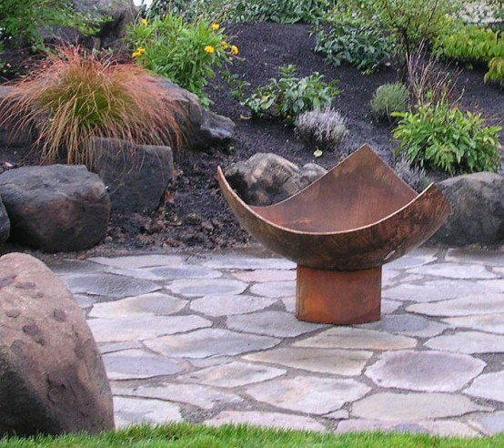 an open aged metal fire bowl is a great idea for a mid-century modern outdoor space, it's easy to DIY and it looks pretty simple to blend with the surroundings