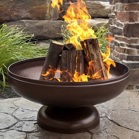 a large dark metal fire bowl is a classic idea for any backyard, and its laconic design lets it to fit any style and any decor