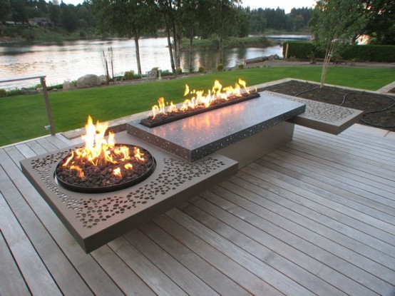 a unique metal construction featuring two fire sources and a seat looks especially cool in front of a water feature