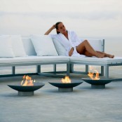 a series of mini metal fire bowls is a great soluton for a contemporary or minimalist space and they work for small outdoor spaces, too