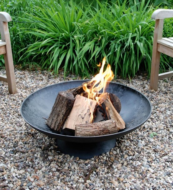 a simple black forged metal bowl is a lovely idea for any backyard, it won't break the bank and will give coziness to the space