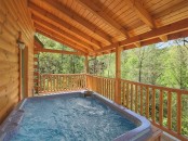 a deck with a built-in outdoor jacuzzi and a view of the forest is a gorgeous space to relax in, it looks amazing