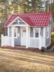 a cool small kids’ playhouse in grey and white, with a red roof, a small porch is a cute and lovely rustic idea