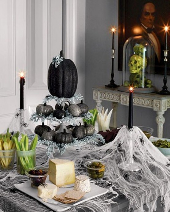 Awesome Pumpkin Centerpieces For Fall And Halloween Table If you used pumpkins for fall decor you could paint them in black for Halloween. It's a great way to reuse them.