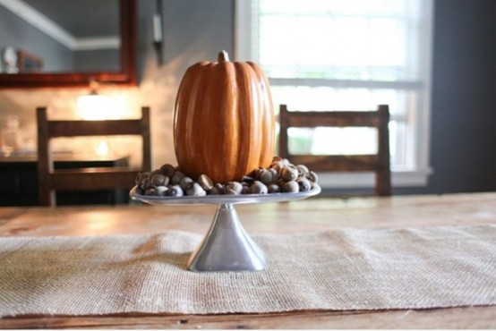 For a minimalist centerpiece put some chestnuts and a single pumpkin on a cake stand.