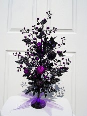 a black tree with purple berries and pomgranates, black butterflies is a creative and bold decoration for Halloween