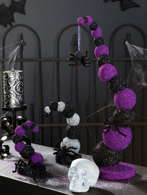 a bold black, white and purple ball installation with skulls and candles is a creative and pretty decor idea for Halloween