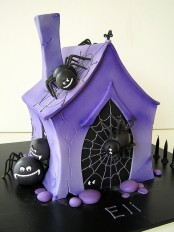 a unique Halloween cake styled as a purple house covered with black spiders is a bold solution that will surprise and excite everyone
