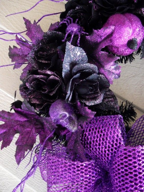 a bold black and purple Halloween wreath with mesh ribbon, skulls and dark blooms is a very cool and bold idea