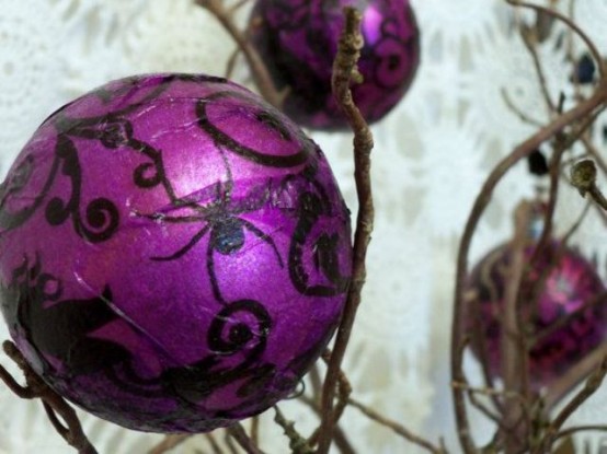 branches with purple and black ornaments are a pretty alternative to a Halloween tree and look very bold
