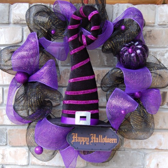 a black and purple mesh ribbon Halloween wreath with a witch's hat is a lovely and fun decor idea for Halloween