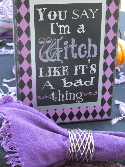 a black and purple Halloween sign is a cool solution to style your space for this spooky holiday