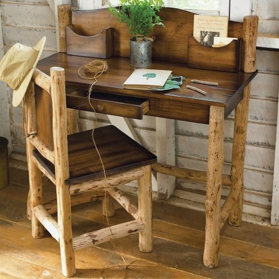 a rustic home office with whitewashed wooden walls, a dark stained desk and chair plus greenery in a pot