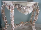 a beautiful console table covered with seashells and mother of pearl is a beautiful piece to rock