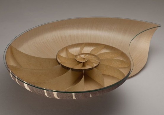 a chic coffee table of plywood and glass inspired by a seashell is a cool solution for a coastal space