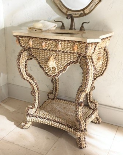 a sea-inspired vanity clad with seashells and pebbles looks unusual, bold and catchy and a stone countertop adds interest