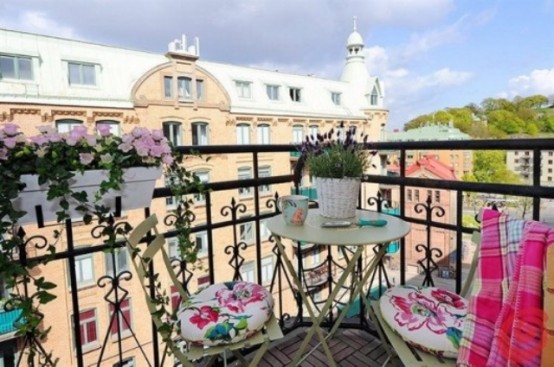 some railing pots with blooms, colorful blankets and floral cushions are nice for refreshing your balcony for spring