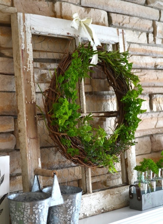 a rustic summer mantel with a shabby chic window, a greenery wreath, metal buckets and greenery in vases