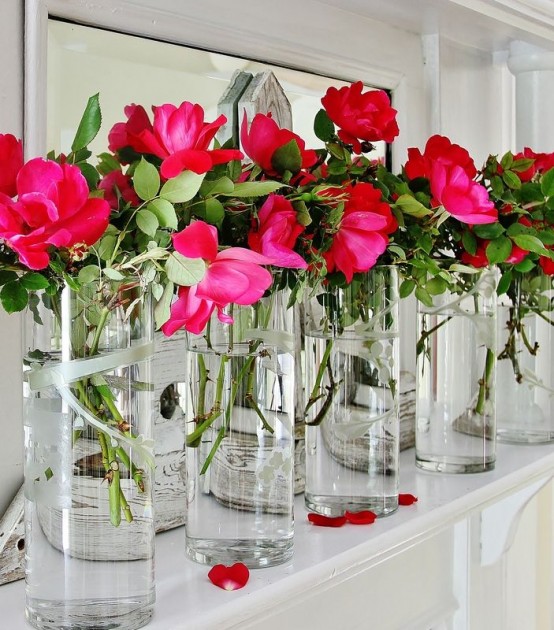 decorate your mantel with clear vases and bright pink blooms and place a mirror behind them to make the space brighter