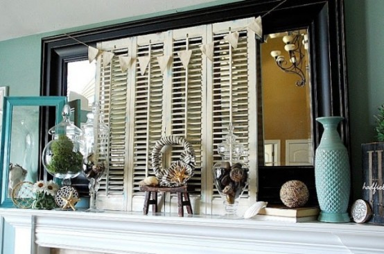a summer mantel with shutters, a turquoise vase, a jar with moss, starfish, shells and a banner