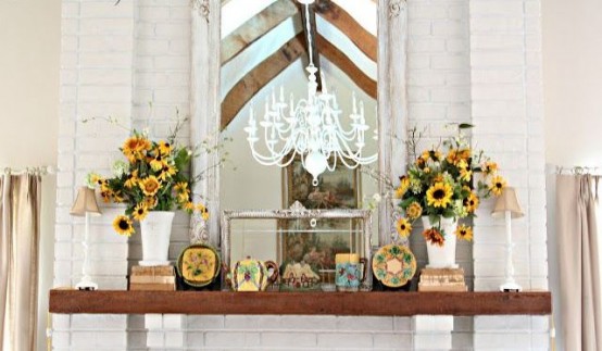 a rustic summer mantel with burlap lamps, vintage books, sunflowers and vintage teaware