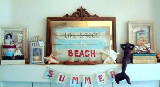 a beachy summer mantel with a pallet sign, framed signs, banners, seashells and starfish