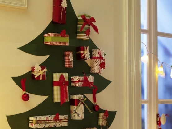 a Christmas tree painted right on the wall and decorated with bold ornaments and gift boxes attached to the wall is awesome