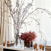 a lovely snowy branch arrangement with tiny ornaments can become a nice centerpiece on a Christmas table