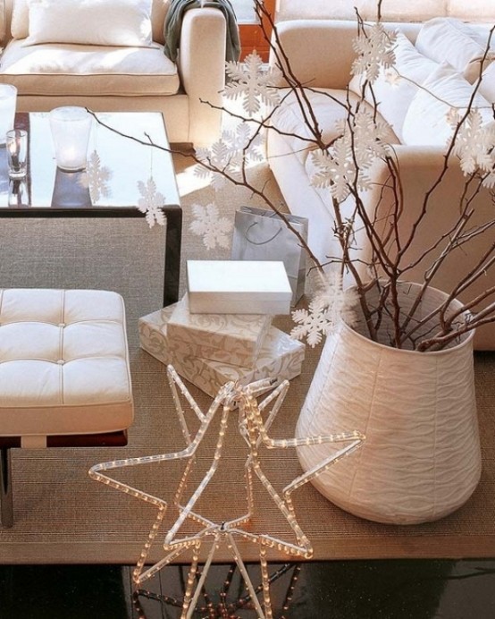a white vase with branches and white snowflakes as decor is a gorgeous idea for a Scandinavian or modern neutral space