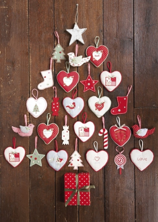 a wall mounted Christmas tree composed of heart, star and tree ornaments in red and white, is amazing