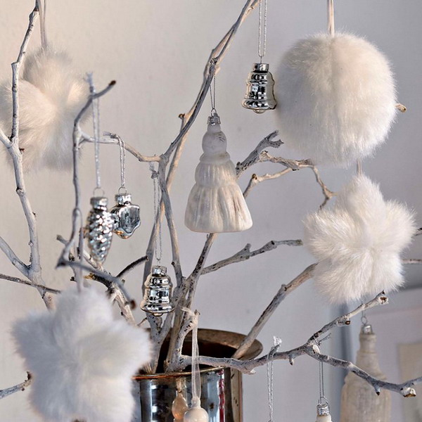 branches in a silver vase with white tassels, faux fur ornaments and some vintage silver ones is a simple and cool alternative to a usual Christmas tree