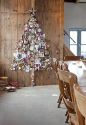 a wall art Christmas tree composed of ornaments, artworks and toys is a unique solution for a quirky space, it looks amazing