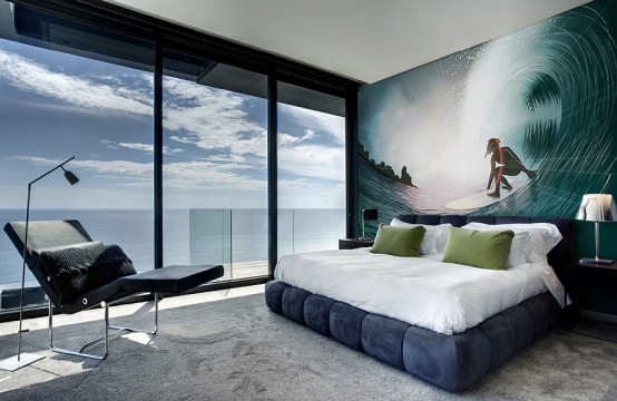 a contemporary beachy bedroom with a full view and a gorgeous surfing wall mural that helps to emmbrace the location