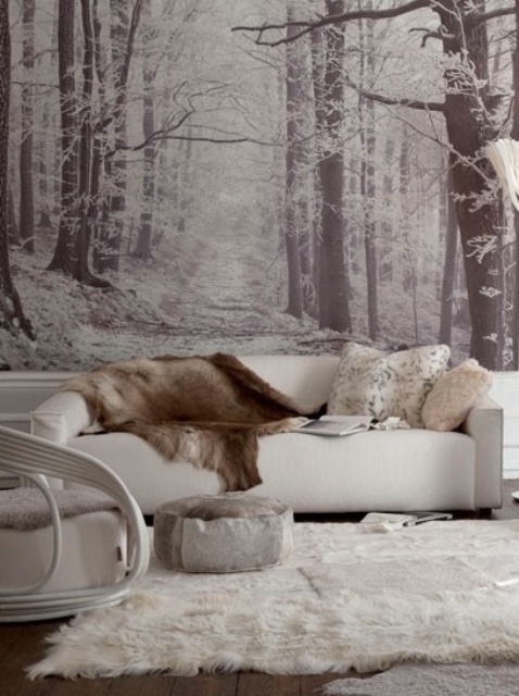 a black and white woodland wall mural matches the color scheme of the space and gives it more eye-catchiness