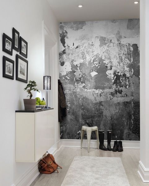 a neutral contemporary entryway with a catchy black and white graphic wall mural that brings a bold and catchy look