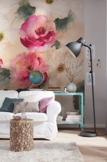 a bright living room with a colorful floral wall mural and bright furniture and lamps for a welcoming feel