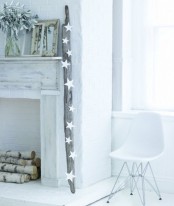 a non-working fireplace clad with whitewashed wood and brick plus firewood inside is a romantic and lovely idea