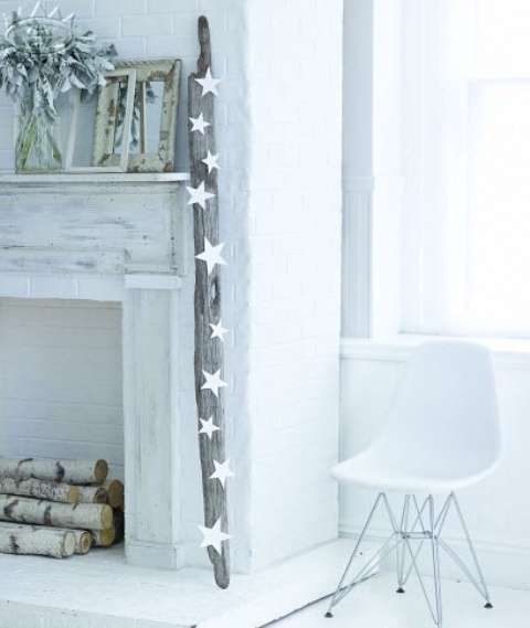 a non-working fireplace clad with whitewashed wood and brick plus firewood inside is a romantic and lovely idea