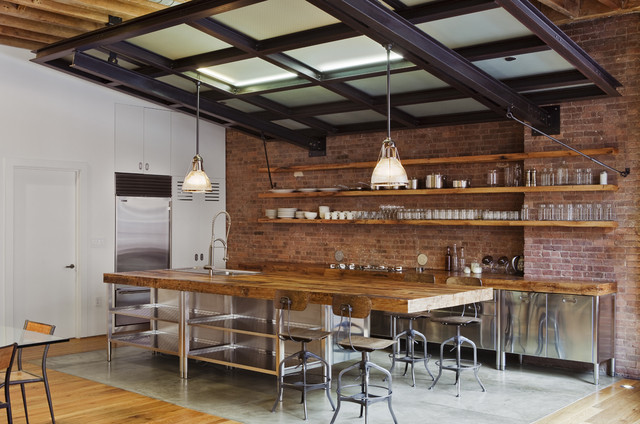 bare brick walls, rustic wood and stainless steel cabinets make this kichen look quite industrial