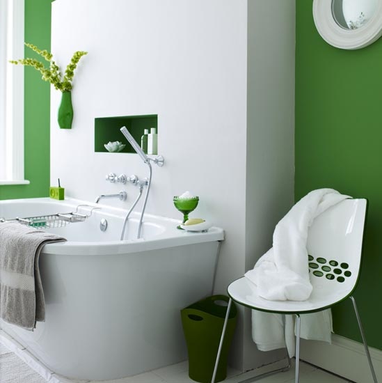 a bold green and white bathroom with a green wall planter with greenery to make the space lively and more nature inspired